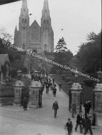 LEAVING CHURCH AFTER MISSION STATUE OF ARCHBISHOP OUTSIDE CATHEDRAL